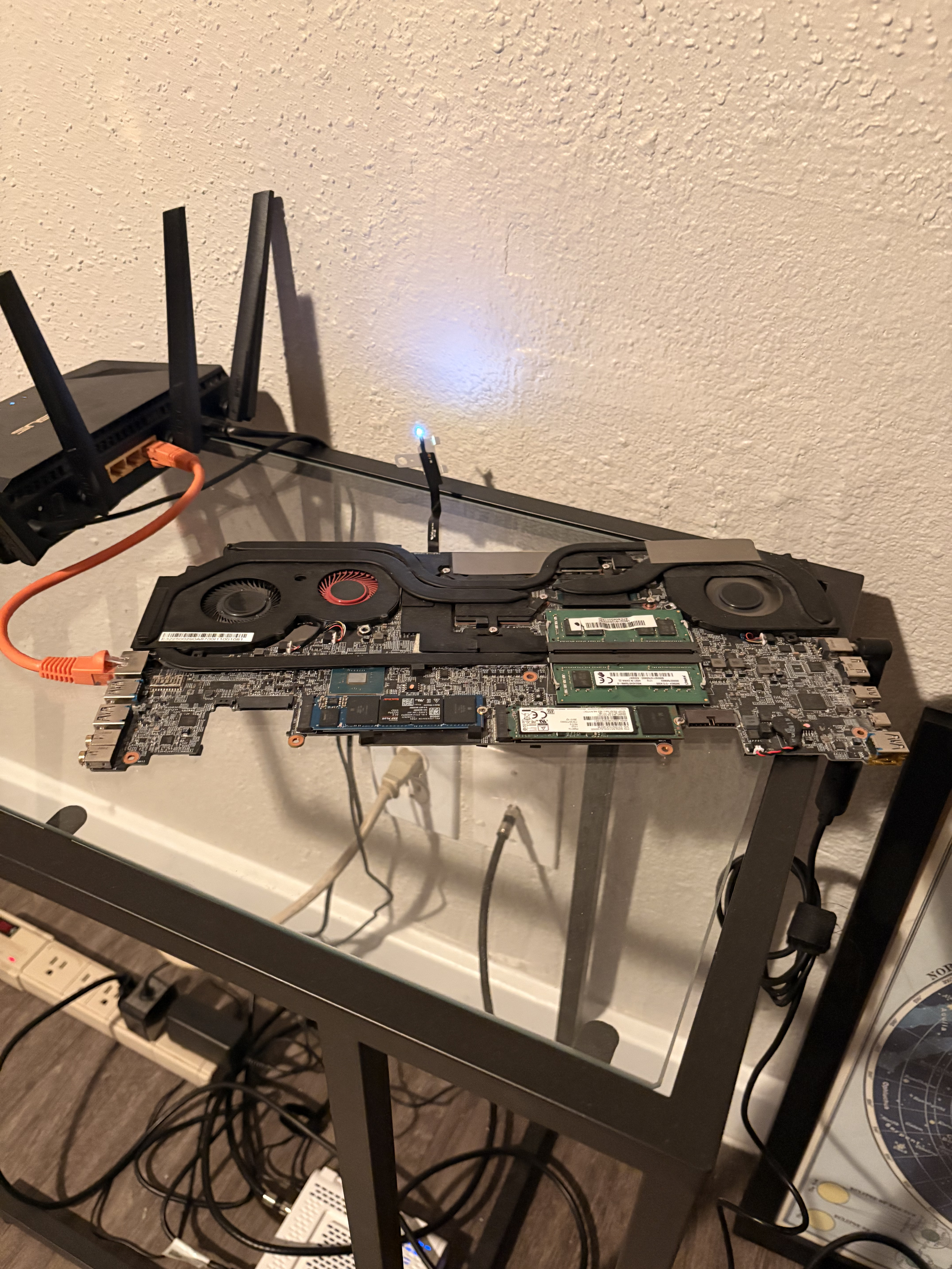 MSI GS65 motherboard connected to an ASUS router with an orange ethernet cable, running as a home server